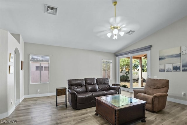 2512 Huber Heights Dr, Las Vegas, NV 89128 - living room featuring ceiling fan, vaulted ceiling, healthy amount of natural light, and light wood finished floors