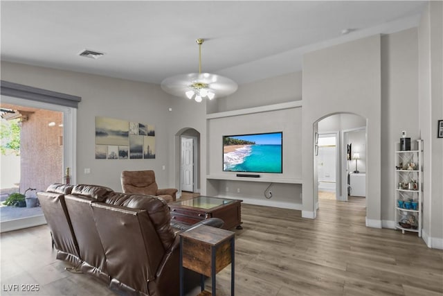 2512 Huber Heights Dr, Las Vegas, NV 89128 - living room with arched walkways, wood finished floors, and ceiling fan