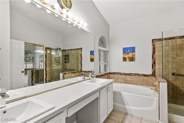 2512 Huber Heights Dr, Las Vegas, NV 89128 - bathroom with a shower stall, double vanity, a garden tub, and tile patterned flooring