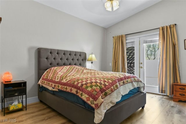 2512 Huber Heights Dr, Las Vegas, NV 89128 - bedroom with access to exterior, vaulted ceiling, and wood finished floors