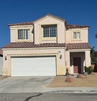 9612 Flying Eagle Ln, Las Vegas, NV 89123 - view of front facade featuring a tiled roof, an attached garage, concrete driveway, and stucco siding