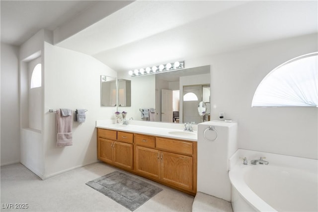9604 Summer Cypress St, Las Vegas, NV 89123 - bathroom featuring a garden tub, double vanity, and vaulted ceiling