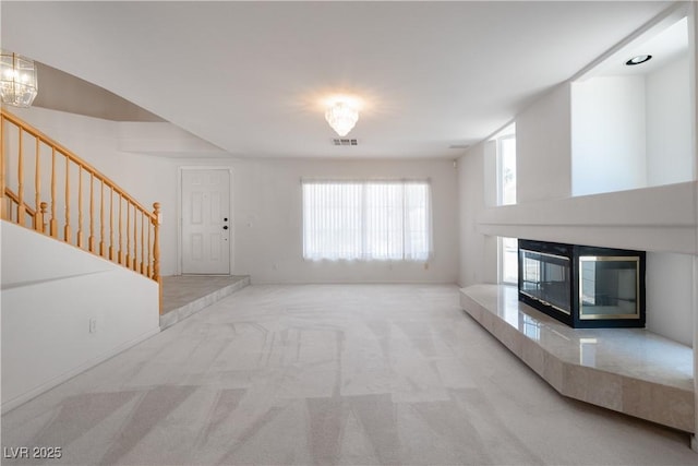 9604 Summer Cypress St, Las Vegas, NV 89123 - unfurnished living room featuring carpet flooring, stairway, and a high end fireplace