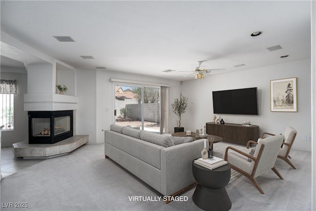 9604 Summer Cypress St, Las Vegas, NV 89123 - living area with a multi sided fireplace, light colored carpet, plenty of natural light, and ceiling fan
