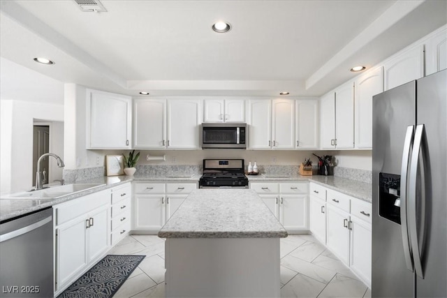9604 Summer Cypress St, Las Vegas, NV 89123 - kitchen featuring appliances with stainless steel finishes, recessed lighting, a kitchen island, light marble finish flooring, and white cabinets