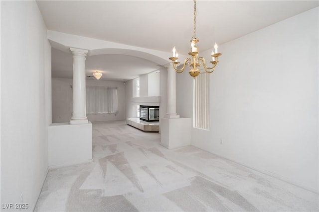9604 Summer Cypress St, Las Vegas, NV 89123 - unfurnished living room with light colored carpet, a multi sided fireplace, decorative columns, and a chandelier