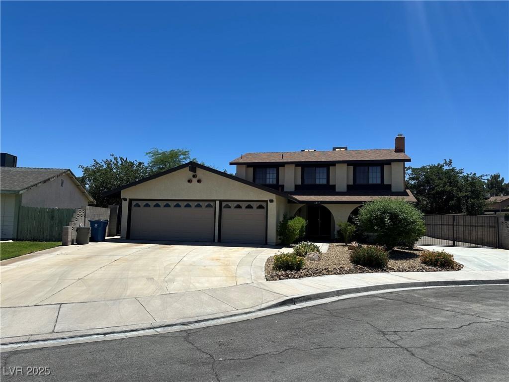 6817 Neepawa Cir, Las Vegas, NV 89108 - view of front of property with an attached garage, stucco siding, concrete driveway, and a chimney