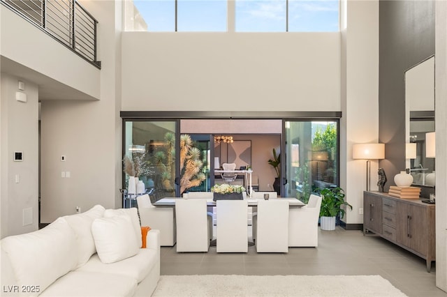12 Desert Lake Ln, Henderson, NV 89011 - living area featuring a high ceiling, light tile patterned floors, a chandelier, and healthy amount of natural light