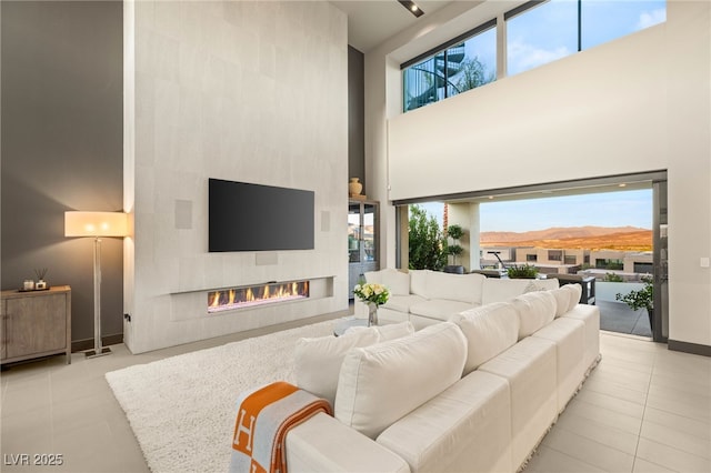 12 Desert Lake Ln, Henderson, NV 89011 - tiled living room featuring a high ceiling, plenty of natural light, and a large fireplace