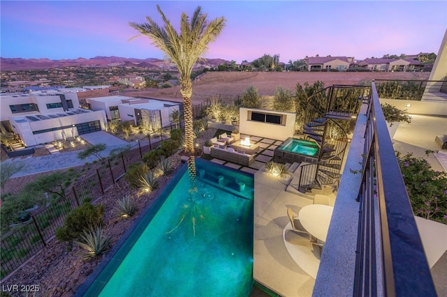 12 Desert Lake Ln, Henderson, NV 89011 - view of pool with a fenced backyard, a patio, a mountain view, and an outdoor living space with a fire pit