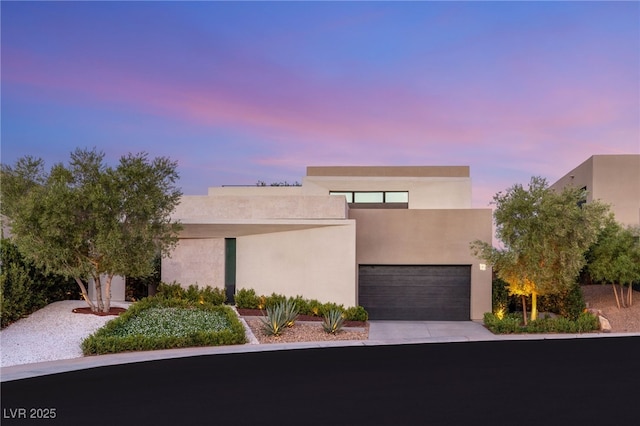 12 Desert Lake Ln, Henderson, NV 89011 - view of front of home featuring driveway, stucco siding, and a garage
