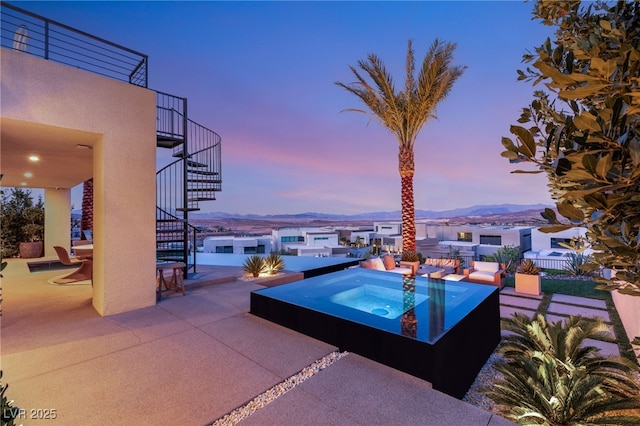 12 Desert Lake Ln, Henderson, NV 89011 - view of swimming pool with stairs, an outdoor hot tub, a patio, and a mountain view