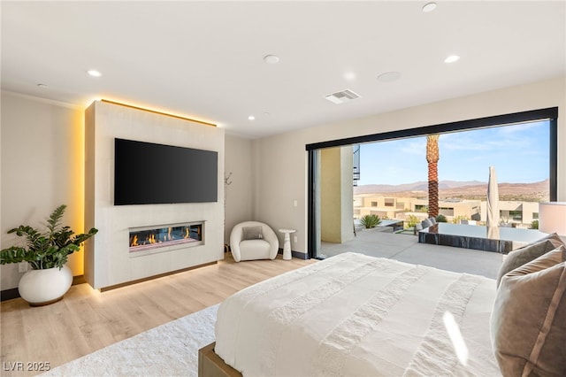 12 Desert Lake Ln, Henderson, NV 89011 - bedroom with a large fireplace, wood finished floors, recessed lighting, and access to outside