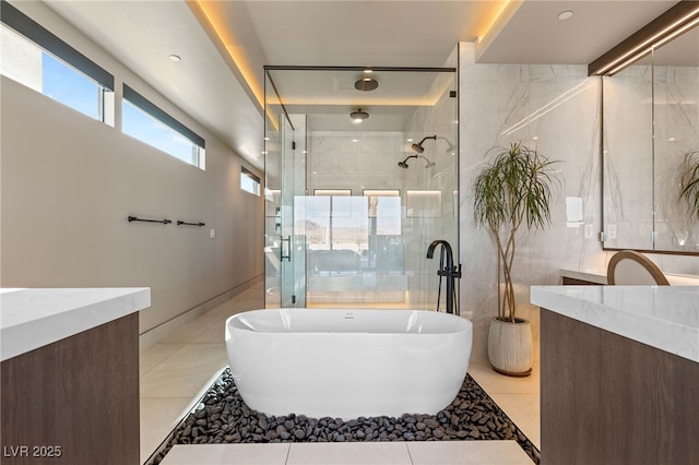 12 Desert Lake Ln, Henderson, NV 89011 - bathroom with vanity, a freestanding bath, tiled shower, tile walls, and tile patterned flooring