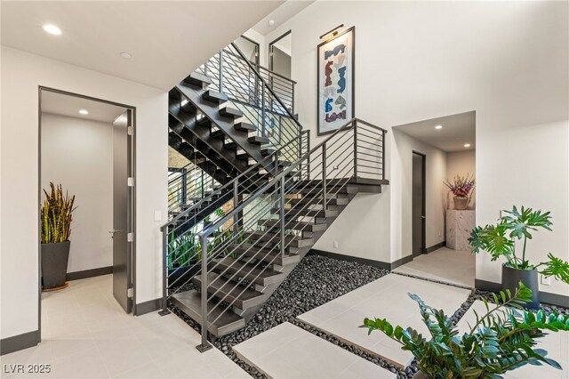 12 Desert Lake Ln, Henderson, NV 89011 - staircase featuring recessed lighting, tile patterned flooring, and a high ceiling