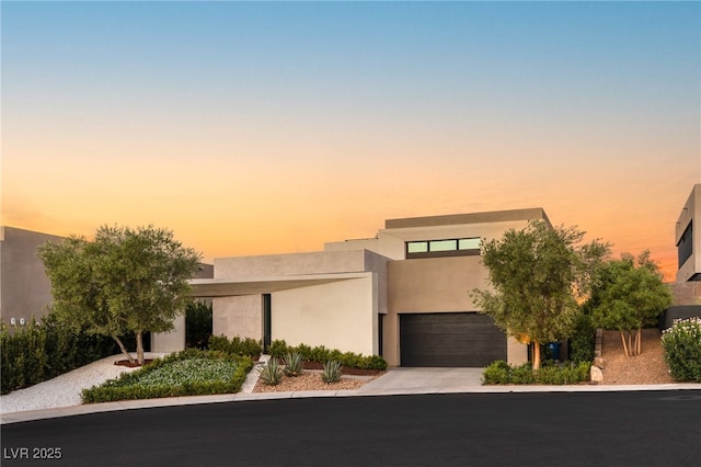 12 Desert Lake Ln, Henderson, NV 89011 - view of front of property featuring stucco siding, concrete driveway, and an attached garage
