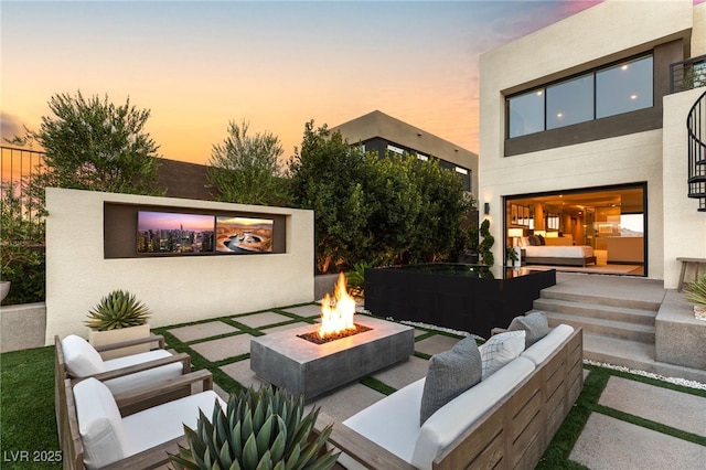 12 Desert Lake Ln, Henderson, NV 89011 - patio terrace at dusk featuring an outdoor living space with a fire pit and a patio area