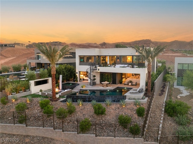 12 Desert Lake Ln, Henderson, NV 89011 - rear view of property featuring a fenced backyard, stairs, a balcony, an in-ground hot tub, and stucco siding