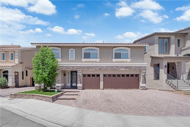 5788 Robin Ridge Ave, Las Vegas, NV 89141 - view of front facade featuring stone siding, stucco siding, a garage, and decorative driveway