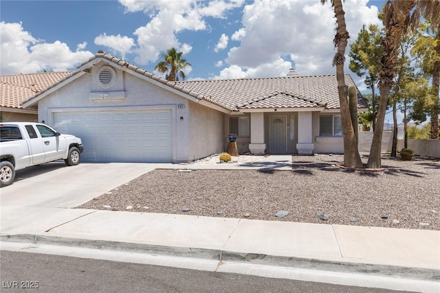 998 Hunters Run Dr, Henderson, NV 89002 - ranch-style home featuring a garage, a tiled roof, concrete driveway, and stucco siding