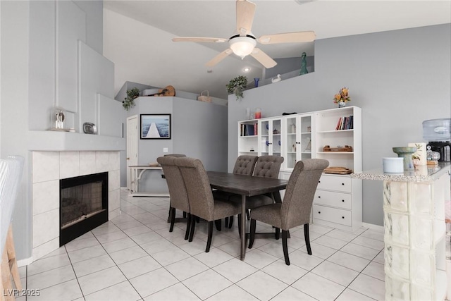 998 Hunters Run Dr, Henderson, NV 89002 - dining space featuring high vaulted ceiling, ceiling fan, light tile patterned flooring, and a tiled fireplace