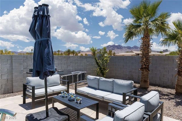 998 Hunters Run Dr, Henderson, NV 89002 - fenced backyard featuring an outdoor hangout area, a patio area, and a mountain view