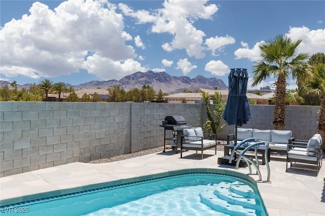 998 Hunters Run Dr, Henderson, NV 89002 - view of swimming pool featuring a mountain view, an outdoor living space, area for grilling, a patio, and a fenced backyard
