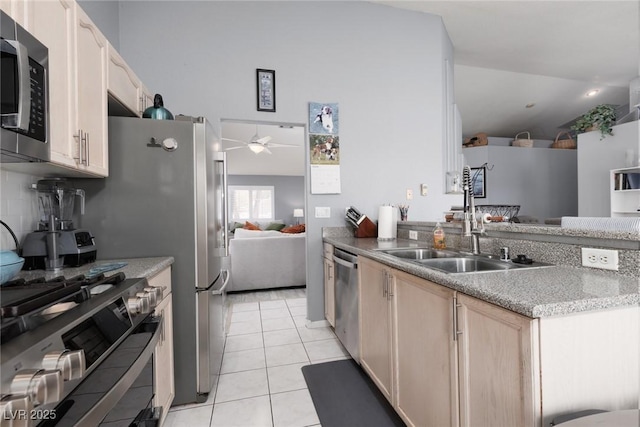 998 Hunters Run Dr, Henderson, NV 89002 - kitchen with appliances with stainless steel finishes, ceiling fan, light brown cabinets, light tile patterned flooring, and a peninsula