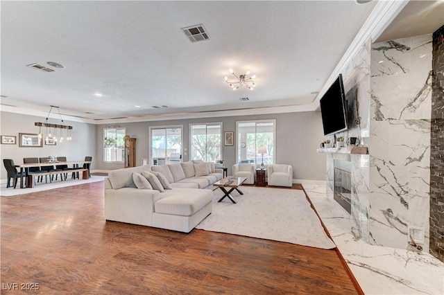 5913 Audria Falls Ave, Las Vegas, NV 89131 - living area featuring ornamental molding, a chandelier, plenty of natural light, a premium fireplace, and recessed lighting