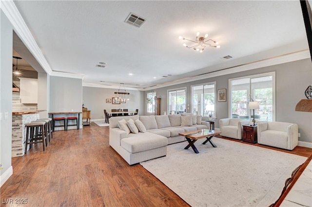 5913 Audria Falls Ave, Las Vegas, NV 89131 - living room with a chandelier, ornamental molding, wood finished floors, and recessed lighting