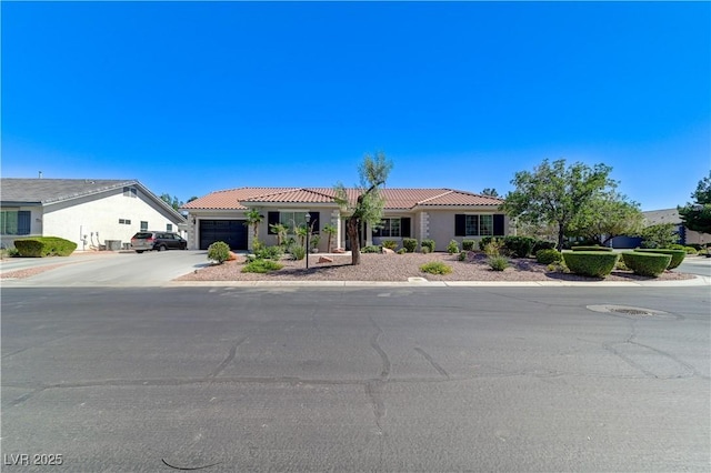 5913 Audria Falls Ave, Las Vegas, NV 89131 - view of front of property with a tile roof, an attached garage, stucco siding, and driveway