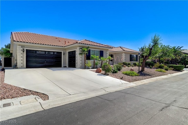 5913 Audria Falls Ave, Las Vegas, NV 89131 - mediterranean / spanish house featuring a tiled roof, an attached garage, driveway, and stucco siding
