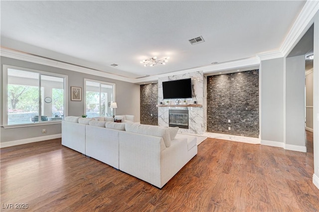 5913 Audria Falls Ave, Las Vegas, NV 89131 - living room with a high end fireplace, crown molding, wood finished floors, and a chandelier
