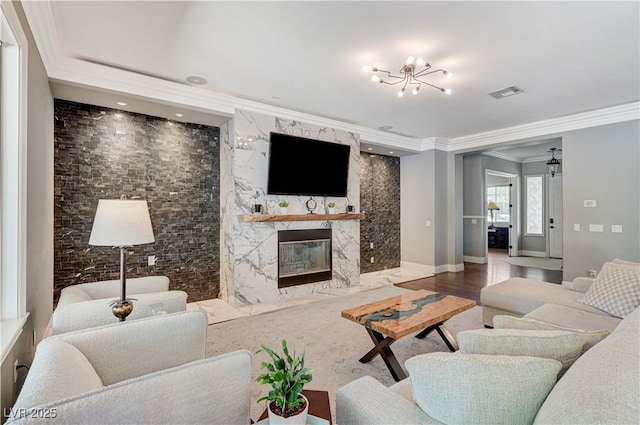 5913 Audria Falls Ave, Las Vegas, NV 89131 - living area with crown molding, a chandelier, and a high end fireplace