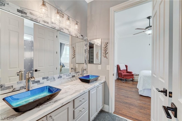 5913 Audria Falls Ave, Las Vegas, NV 89131 - ensuite bathroom with double vanity, a ceiling fan, wood finished floors, and ornamental molding