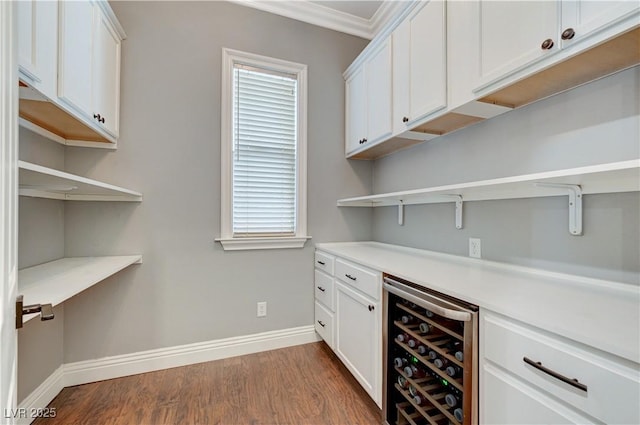 5913 Audria Falls Ave, Las Vegas, NV 89131 - indoor dry bar featuring wine cooler, dark wood finished floors, and crown molding