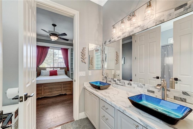 5913 Audria Falls Ave, Las Vegas, NV 89131 - bathroom featuring double vanity, ensuite bath, ceiling fan, and wood finished floors