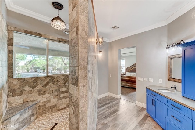 5913 Audria Falls Ave, Las Vegas, NV 89131 - bathroom with ornamental molding, wood finished floors, vanity, a walk in shower, and ensuite bath