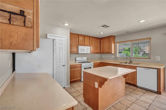 6377 W Haleh Ave, Las Vegas, NV 89141 - kitchen with white appliances, light countertops, a kitchen island, light tile patterned floors, and recessed lighting