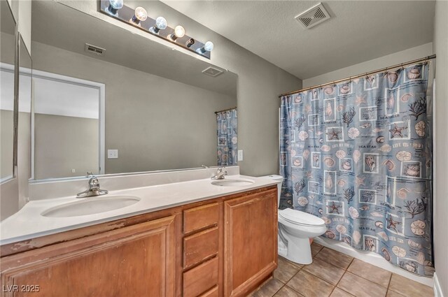 6377 W Haleh Ave, Las Vegas, NV 89141 - bathroom with tile patterned flooring, double vanity, and curtained shower