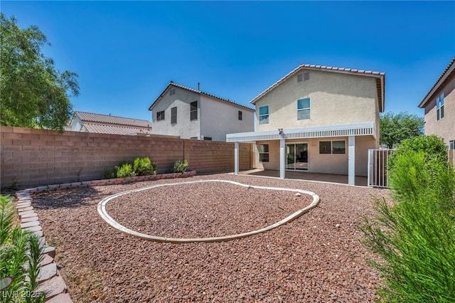 6377 W Haleh Ave, Las Vegas, NV 89141 - back of house with a fenced backyard, stucco siding, and a patio