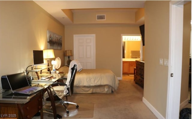 63 E Agate Ave Unit 202, Las Vegas, NV 89123 - bedroom with a tray ceiling, light colored carpet, a desk, and ensuite bath