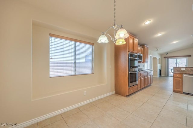 7998 Base Camp Ave, Las Vegas, NV 89178 - kitchen featuring stainless steel appliances, lofted ceiling, light tile patterned floors, a chandelier, and brown cabinets