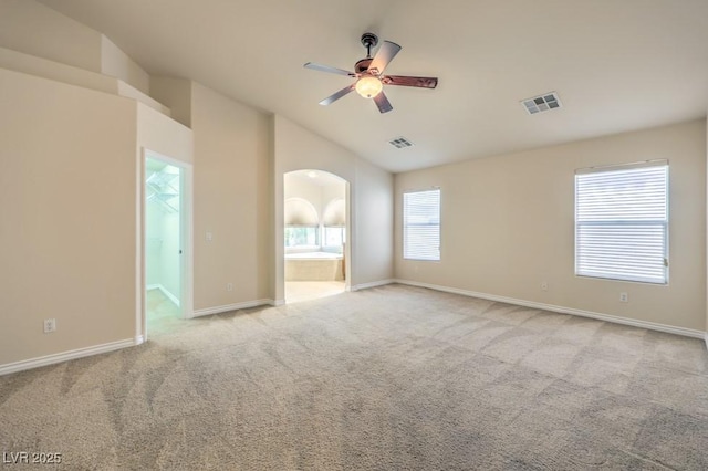 7998 Base Camp Ave, Las Vegas, NV 89178 - unfurnished room with carpet, ceiling fan, lofted ceiling, and arched walkways
