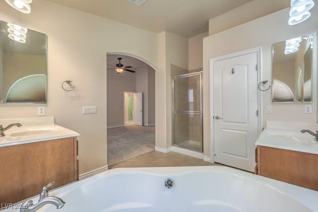 7998 Base Camp Ave, Las Vegas, NV 89178 - bathroom featuring a whirlpool tub, two vanities, tile patterned floors, a stall shower, and ceiling fan