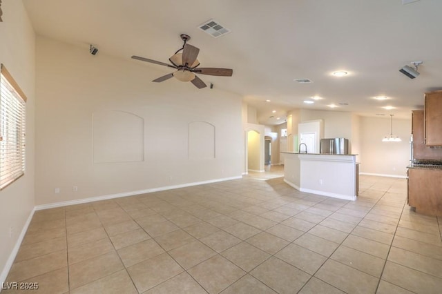 7998 Base Camp Ave, Las Vegas, NV 89178 - unfurnished living room with light tile patterned flooring, ceiling fan, arched walkways, vaulted ceiling, and recessed lighting