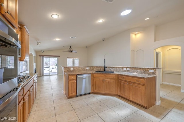 7998 Base Camp Ave, Las Vegas, NV 89178 - kitchen with appliances with stainless steel finishes, vaulted ceiling, arched walkways, ceiling fan, and light stone countertops