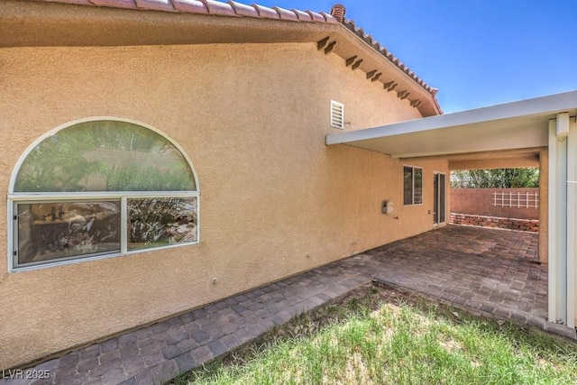 7998 Base Camp Ave, Las Vegas, NV 89178 - view of side of home featuring a patio area and stucco siding