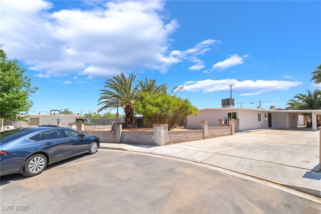 2749 Del Mar Pl, Las Vegas, NV 89169 - view of front facade featuring a fenced front yard, concrete driveway, and a carport