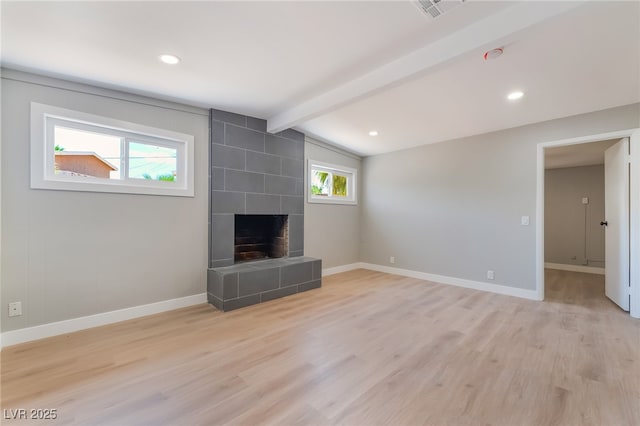 2749 Del Mar Pl, Las Vegas, NV 89169 - unfurnished living room featuring light wood-type flooring, a tile fireplace, and recessed lighting
